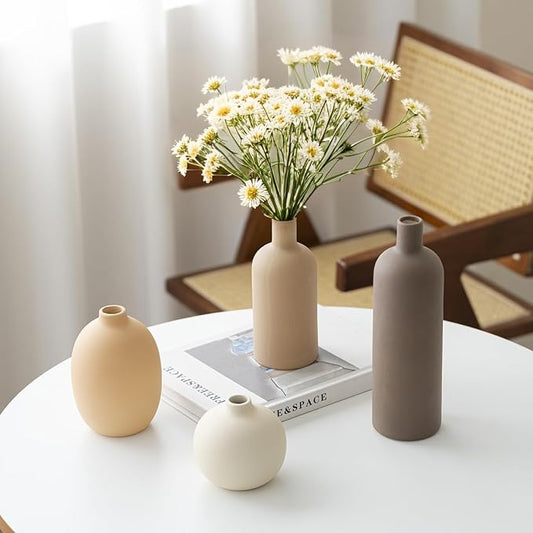 Ceramic vases styled with dried flowers on a table