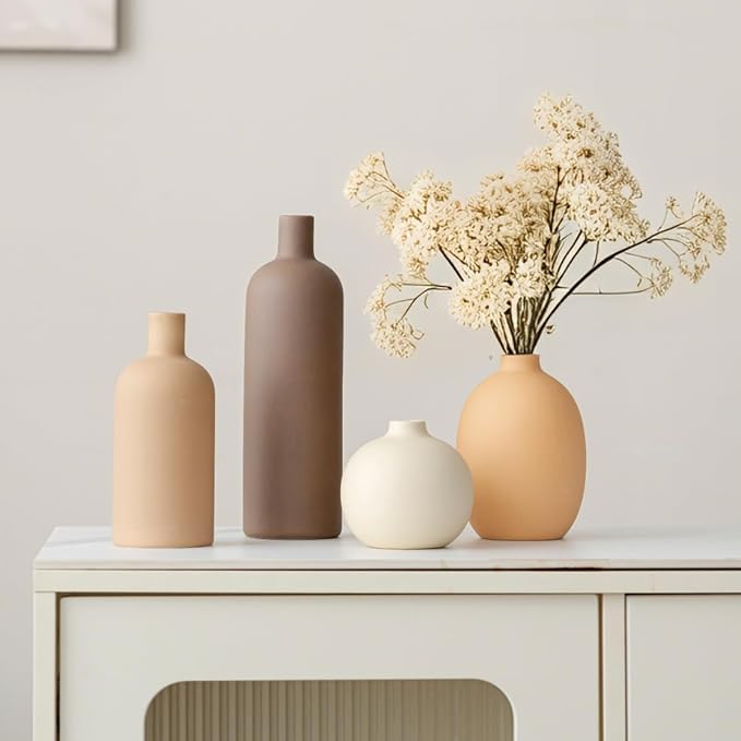 Four ceramic vases in terracotta and cream tones