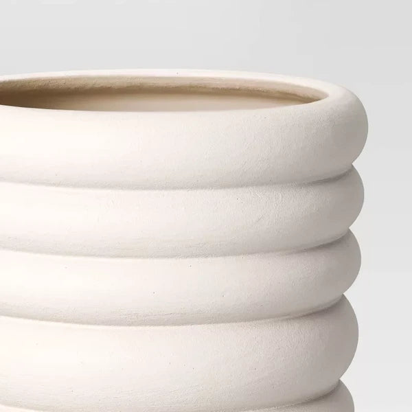 Close-up of the banded texture on the white planter