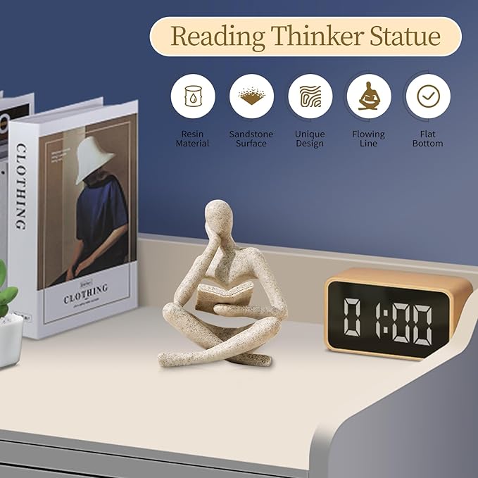 Reading thinker figurine on a shelf with books