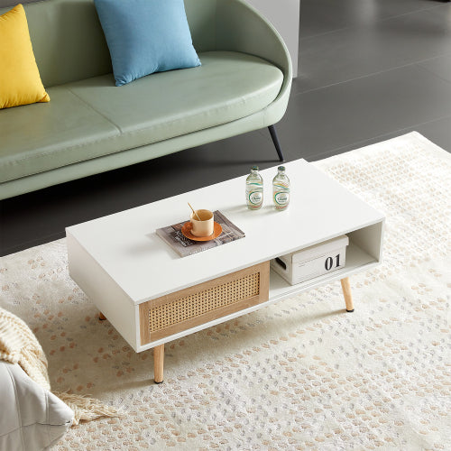 White coffee table with rattan sliding door beside a sofa