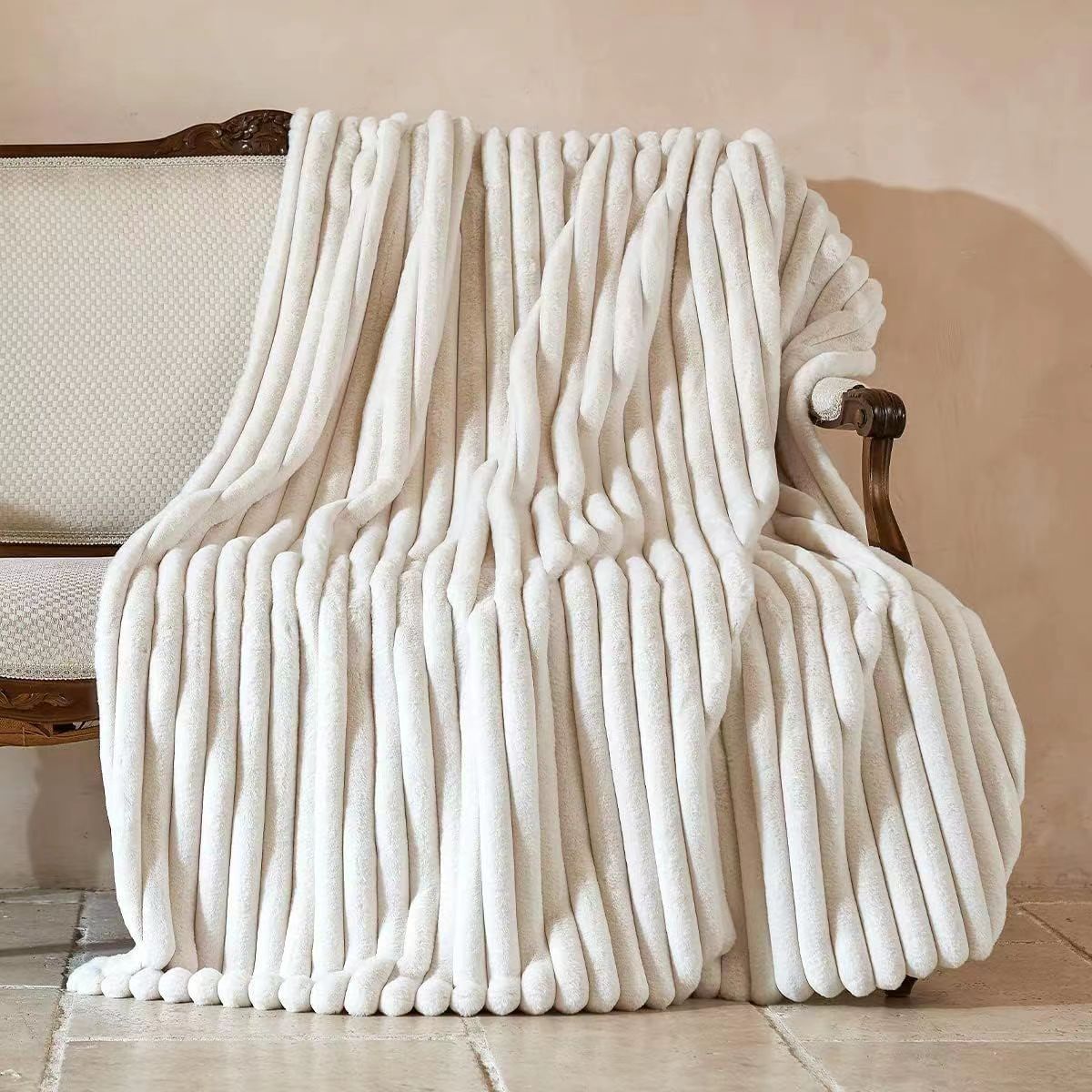 Ivory ribbed faux fur blanket draped over a sofa